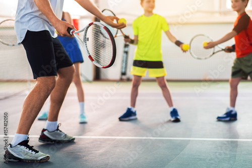Professional tennis player teaching kids