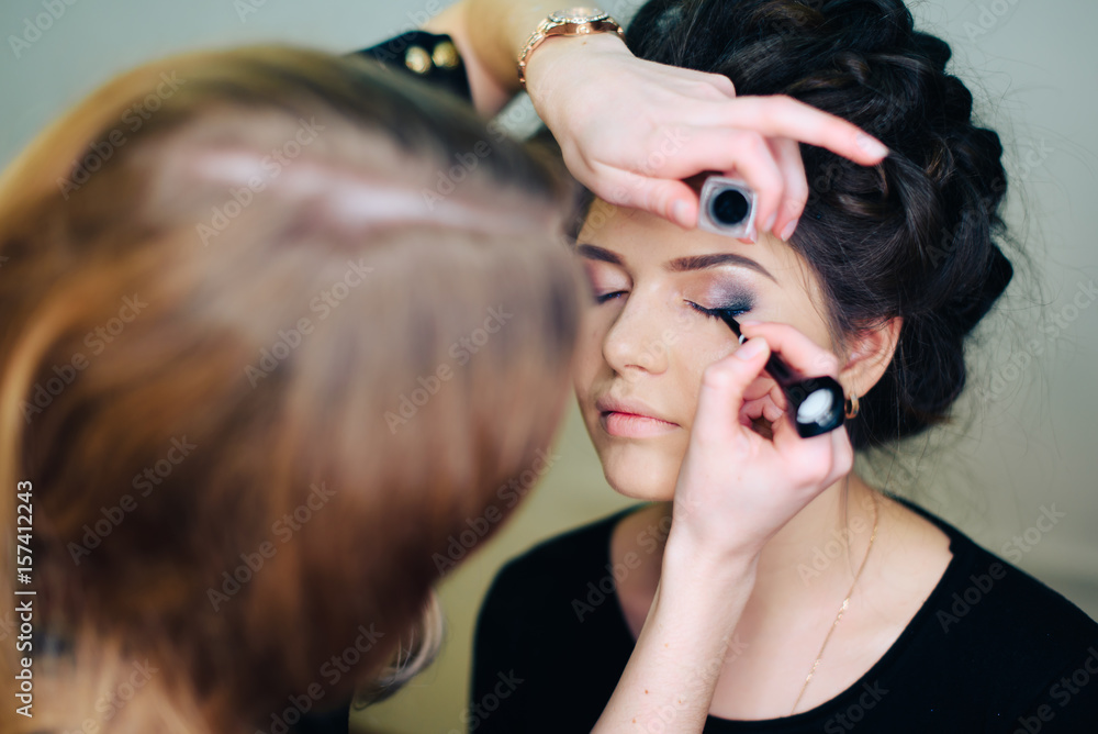 Fototapeta premium stylist working in a beauty salon and a nice lady