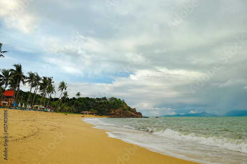 View of cloudy day at tropical beach with mountains on the horizon. Place for relaxation in authentic asian Bungalow at the Maenam beach  Koh Samui  Thailand