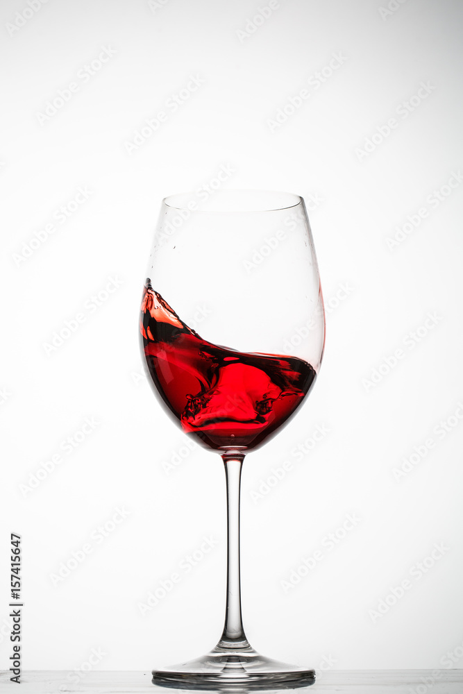 Red wine splashes in a glass Red wine splashes in a glass