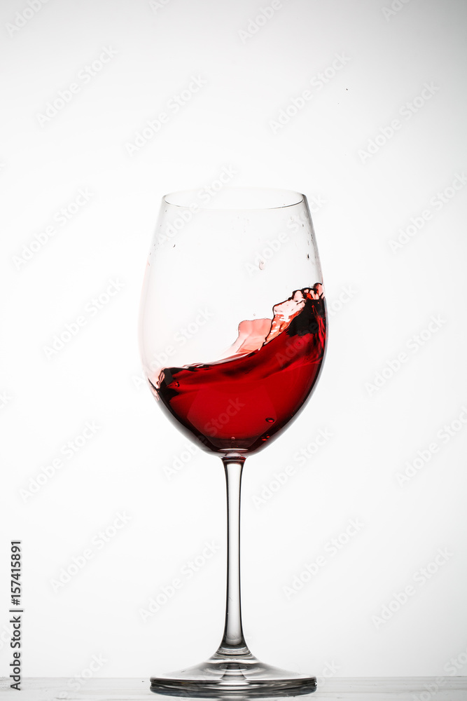 Red wine splashes in a glass Red wine splashes in a glass