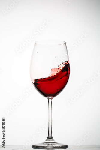 Red wine splashes in a glass