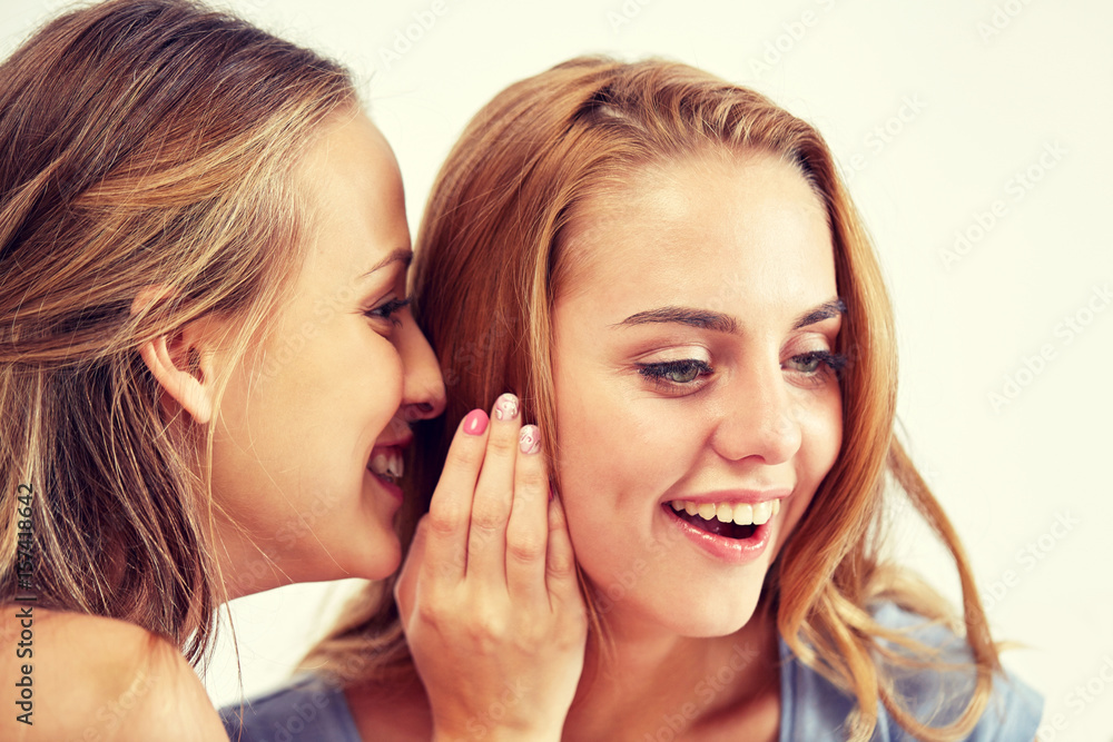 happy young women whispering gossip at home happy young women whispering gossip at home