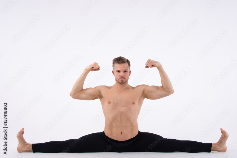 To do the splits. Strong athletic guy. Yoga, aerobics and healthy  lifestyle. A young sexy man doing stretching. foto de Stock | Adobe Stock