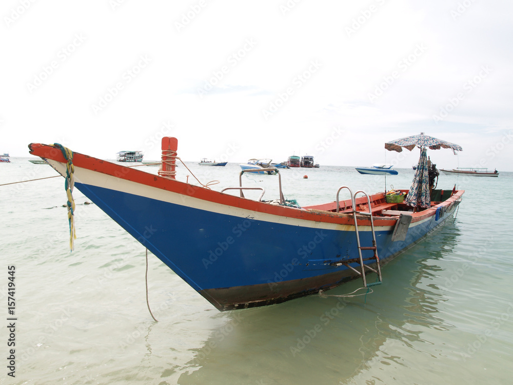 A blue boat for a snorkeling. The boat park on the beach and waiting for tourists to take to the snorkeling