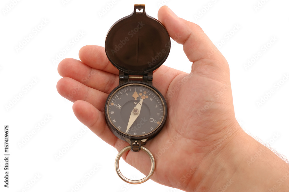 Man's hand with an ancient German officer compass Man's hand with an ancient German officer compass