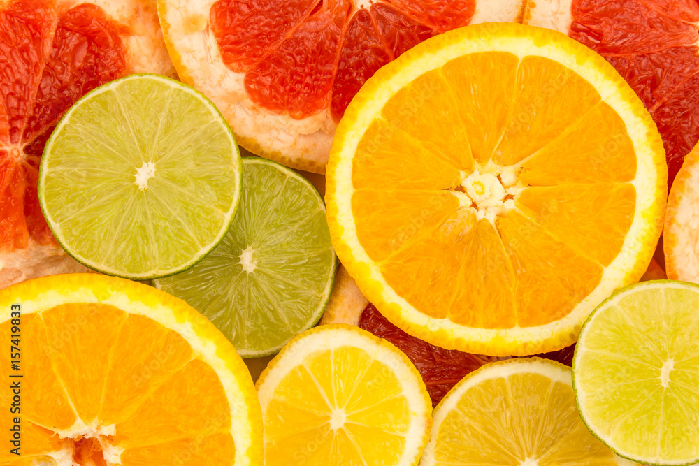 Four slices of citrus fruits, closeup background.