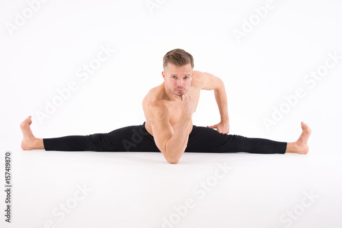 The splits. Fitness and healthy lifestyle. Sexy man and a healthy lifestyle. Sport and strength. 