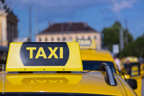 Taxi cars are waiting in row on the street. European tourism and travel concept. Selective focus image