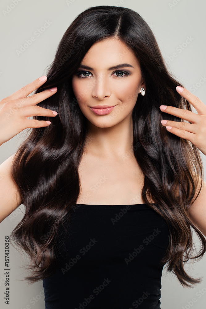 Beautiful Woman with Perfect Brown Hair and Makeup. Young Model with Long Healthy Curly Hairstyle Beautiful Woman with Perfect Brown Hair and Makeup. Young Model with Long Healthy Curly Hairstyle