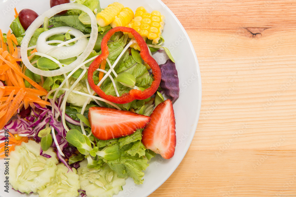 Fresh healthy salad on wooden table. View from above with copy space Fresh healthy salad on wooden table. View from above with copy space