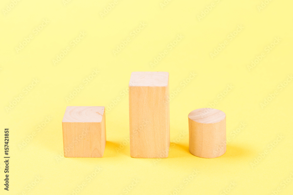 Wooden building blocks on yellow background. Wooden building blocks on yellow background.