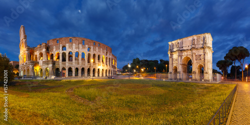 Photography Panorama of The Arch of Titus and Colosseum or Coliseum at night, also known as the Flavian Amphitheatre, the largest amphitheatre ever built, in the centre of the old city of Rome, Italy