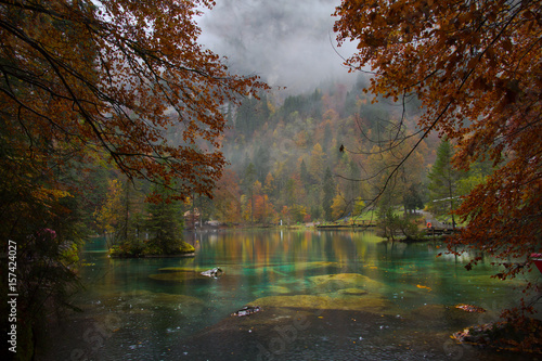 Scenic landscape view of blue lake in Autumn. Crystal clear lake of Blausee Switzerland