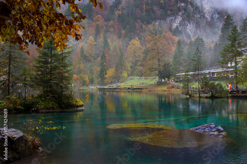 Scenic landscape view of blue lake in Autumn. Crystal clear lake of Blausee Switzerland