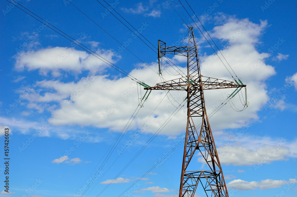 Electrical transmission pylon. High voltage. Blue sky background.