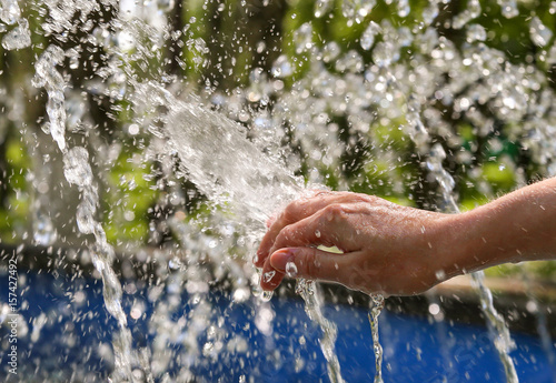 Woman's hand and water spray
