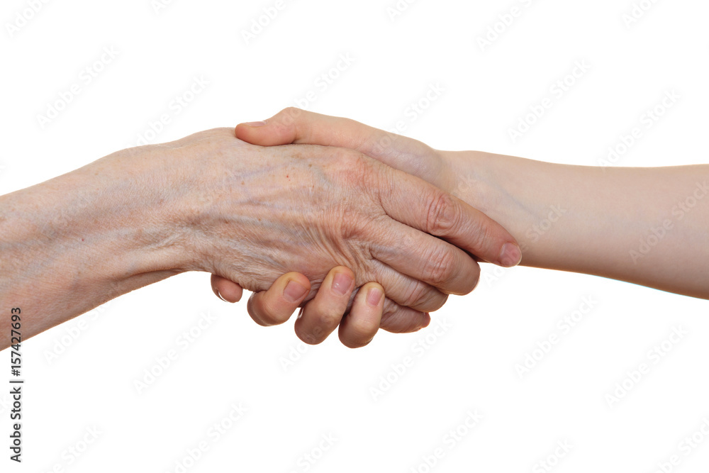 Handshake between an old person with a wrinkled hand and a kid, isolated on white background