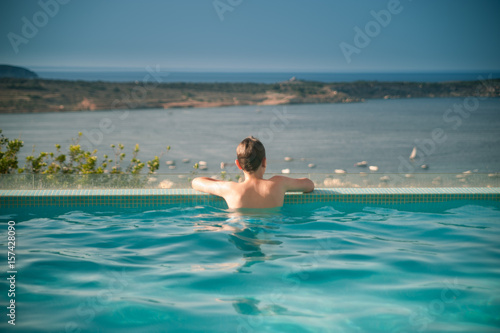 A boy relaxing in a  swimming pool