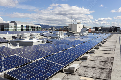 Building rooftop with blue solar panels