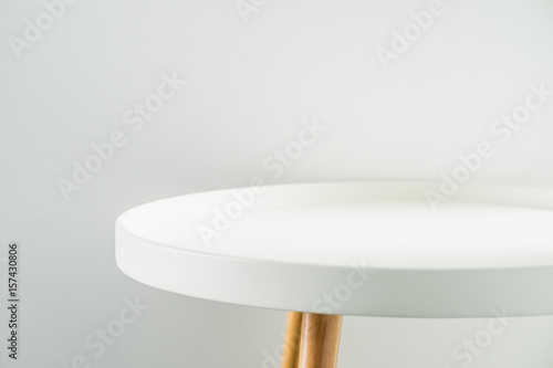 Fototapeta Empty modern round white table top at white house wall,Mock up space for display
