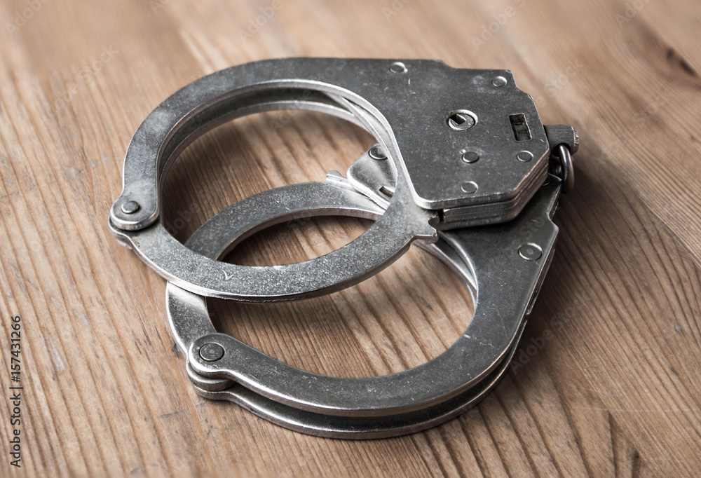 Obraz premium handcuffs. Close-up photo, closed bracelets. Police and crime symbol
