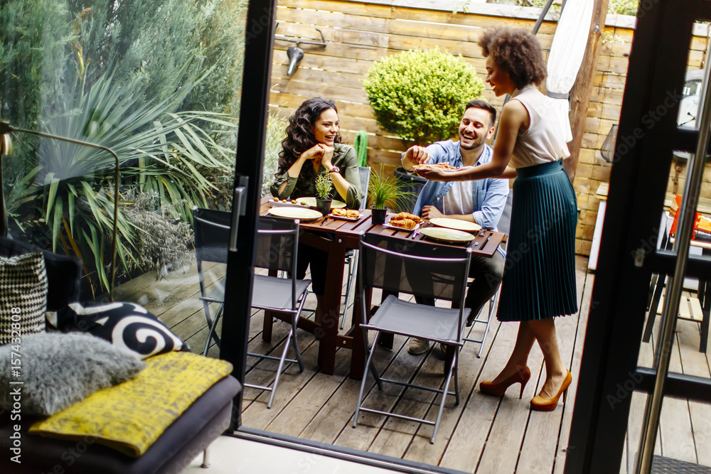 Cheerful young people have lunch in the courtyard and have a fun Cheerful young people have lunch in the courtyard and have a fun