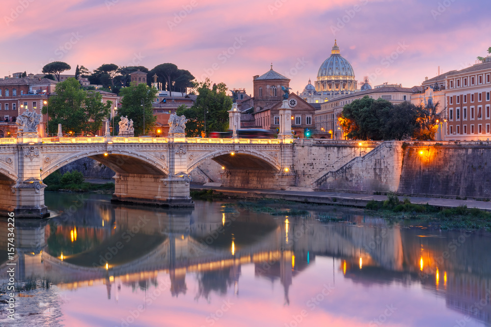 View of Tiber River, bridge Vittorio Emanuele II and Saint Peter Cathedral during beautiful sunset in Rome, Italy.