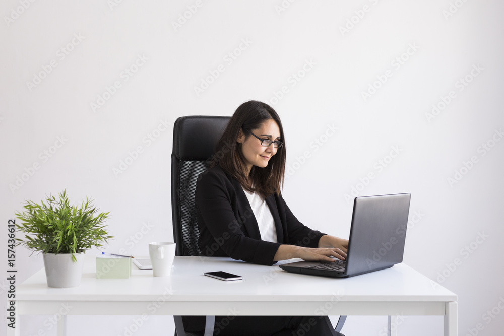 beautiful young Business woman using his laptop in the office. Business Concept.white backgrounds beautiful young Business woman using his laptop in the office. Business Concept.white backgrounds