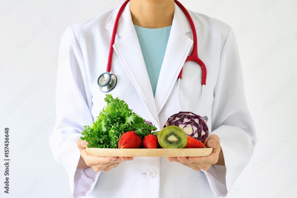 Doctor holding fresh fruit and vegetable, Healthy diet, Nutrition food as a prescription for good health. (Selective Focus) - obrazy, fototapety, plakaty 