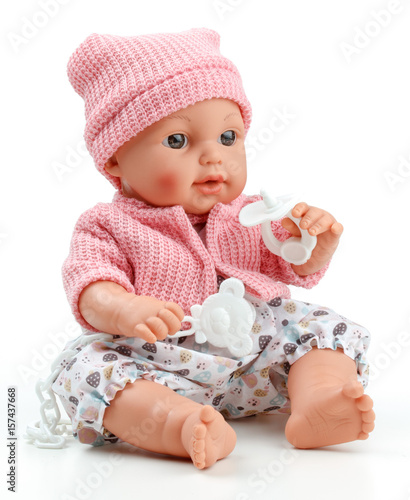 Fotografia Toy doll child, in pink blouse with pacifier on isolated background