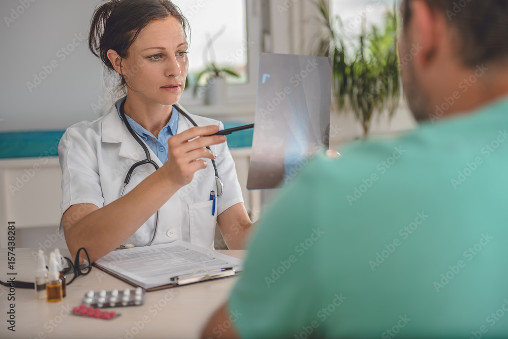 Doctor checking the ankle X-ray Doctor checking the ankle X-ray