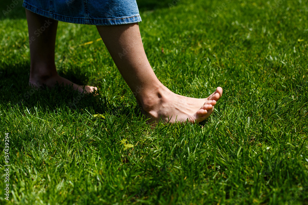 Female legs on green grass Female legs on green grass