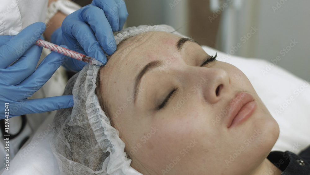 Cosmetic injections in forehead of young patient Cosmetic injections in forehead of young patient