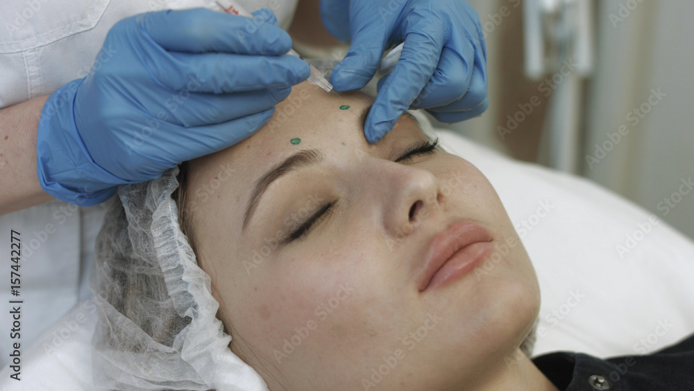 Cosmetic injections in forehead of young patient Cosmetic injections in forehead of young patient