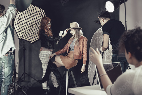 Fashion stylist with model at photoshoot