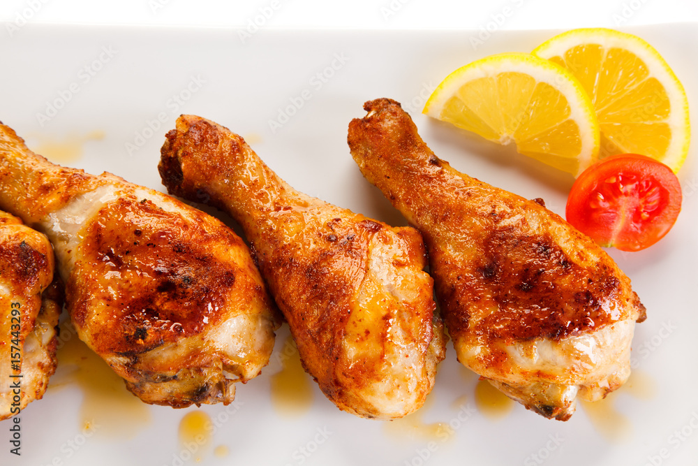 Roast chicken drumsticks on white background Roast chicken drumsticks on white background