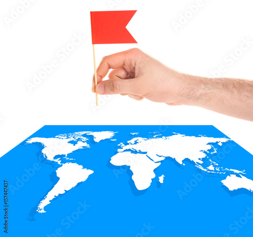 Man placing flag on world m...