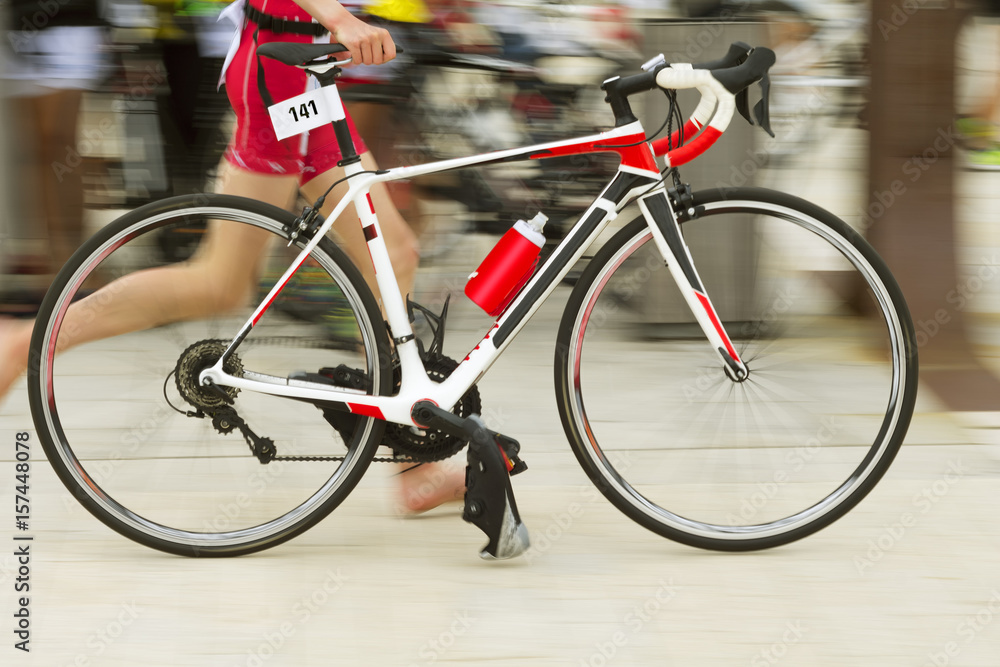 Obraz premium triathlon competitors in ciclyng , cyclist in action and motion