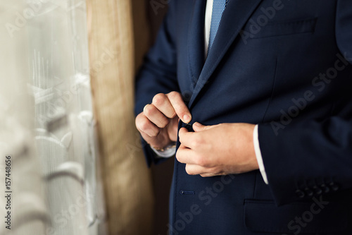 Businessman wears a jacket.Politician, man's style,male hands closeup, American, European businessman, business, fashion and clothing concept