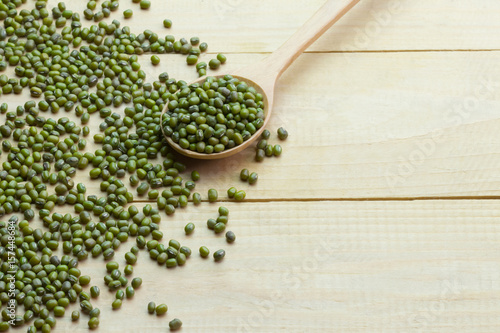 Mung dried bean on wooden spoon on wooden teble.high angle view background