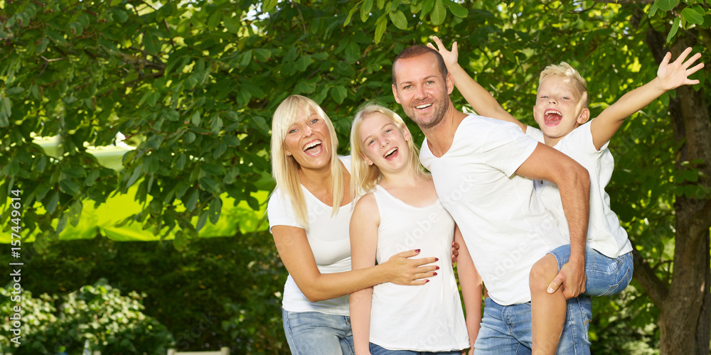 Fototapeta premium Parents giving piggyback ride to children