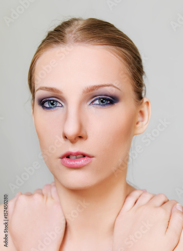 Attractive blonde topless woman with dark eye make up