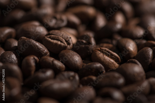 Background of fried coffee beans. Close-up in morning light