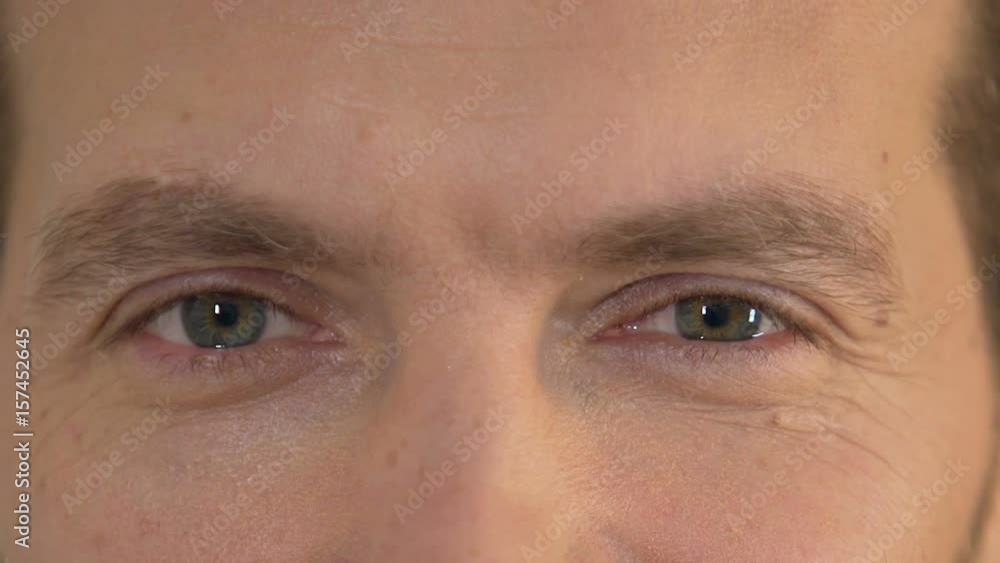 Emotional man looking into camera, male smiling and flirting with someone Emotional man looking into camera, male smiling and flirting with someone