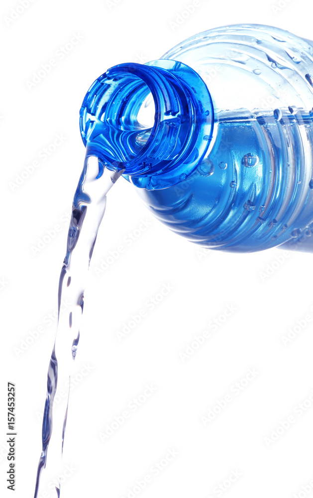 Water pouring from plastic bottle on white background Water pouring from plastic bottle on white background