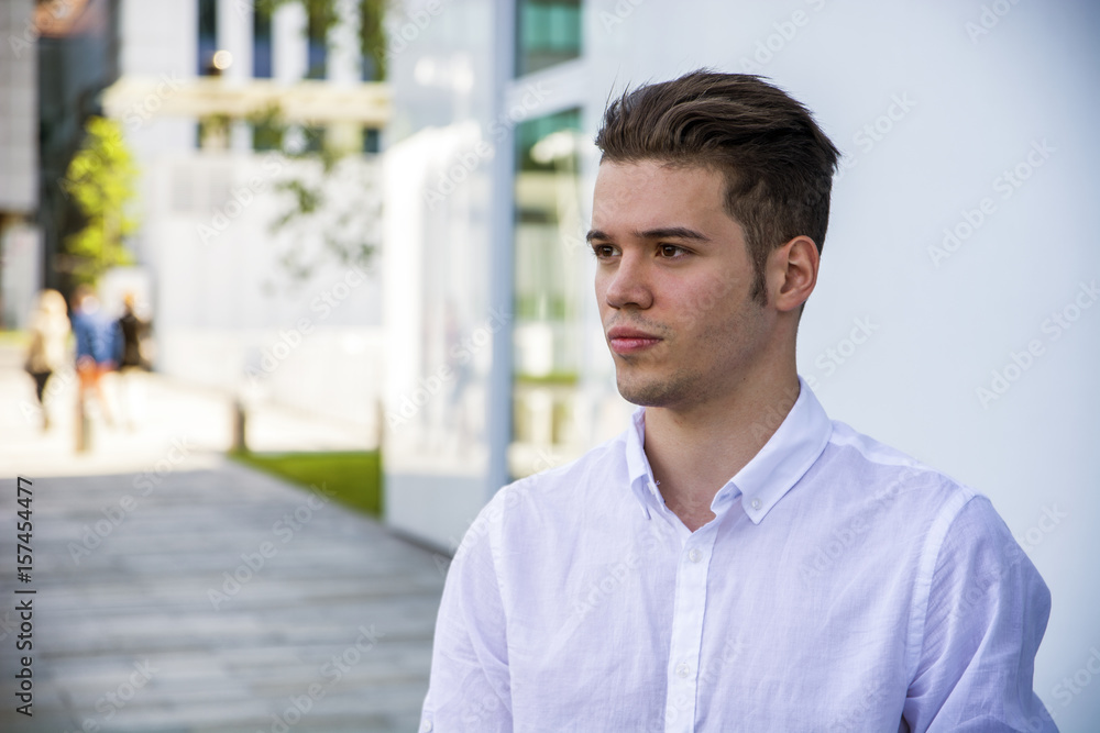 Profile shot of attractive young man in city, looking away, outdoor Profile shot of attractive young man in city, looking away, outdoor