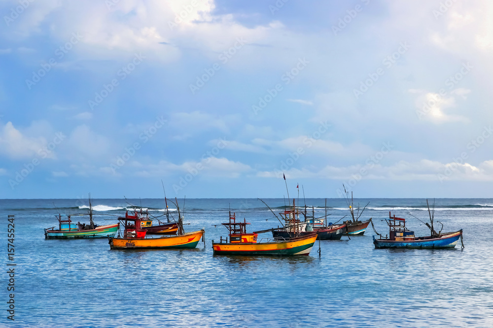 Fishermen colored boats on the water. Indian Ocean. Sri Lanka.
