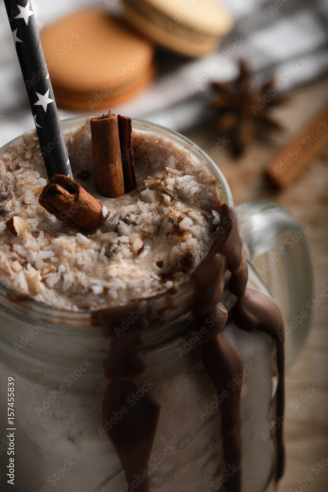 Vanilla, chocolate milkshake drink with cinnamon, coconut milk. Selective focus. Dark mood, and cookies - obrazy, fototapety, plakaty 