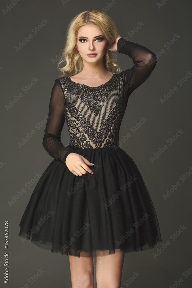 Sensual, blonde model wearing black dress with white pattern. Sensual, blonde model wearing black dress with white pattern.